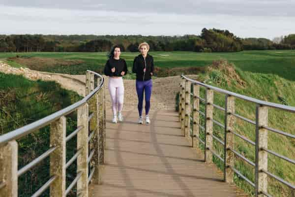 Two women walking for exercise as part of their morning routine